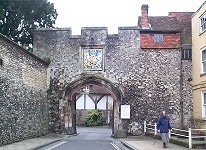 15th Century Prior's Gate. Main entrance to The Close. Plain four-centred arch with original traceried doors. Coat of arms aver arch. Castellated parapet.