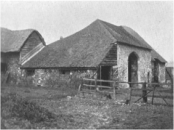 Hyde Abbey Gateway in the days of its use as an entrance to a farmyard, with the side buildings used as a stable.  Owned at the time by Mr W. Barrow Simonds