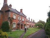 St. John's Hospital (north). Red brick with stone dressings. 2 storeys. Built in Tudor- Gothic style with Jacobean porches. Slate roofs with chimney clusters. Shaped Jacobean gables. Leaded lattice casement windows. Dated 1862 on rainwater heads. Architects. H.C. Brown and T. Stopher.    SU 485 294