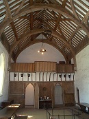The Brethren's Hall (14th Century) showing the musician's gallery and the fine timbered roof made from Spanish Chestnut. The heavy oval table, between the doors, is made from Purbeck Marble and is thought to have come from Winchester Castle.