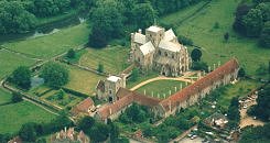 Photo Copyright Hampshire Chronicle - Hospital and Chapel of St. Cross. St. Cross Hospital, founded in 1136 by Henry de Biois, Bishop of Winchester. Church, transitional Norman C. 1 2/13, cruciform with massive central tower. Other buildings principally early C.15, enlarged during bishopric of Cardinal Beaufort. Entered from small court through entrance gate (C.14/15 detail). Main quadrangle with range of fourteen 2-storey almshouses, one tall shafted chimney to each. Hall with 2-light windows adjoins on west side the main gate tower, which has a range of buildings over a cloister on the east side, linking the tower with the church. Varying dates and rebuildings.